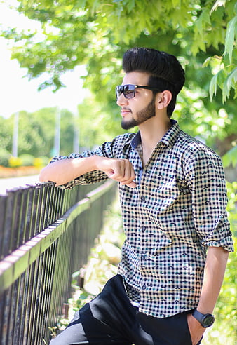 Stylish Man In Checkered Shirt And Sunglasses Leaning On Fence