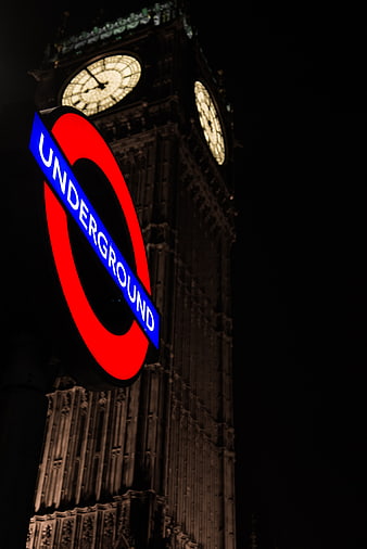 London Underground sign with Big Ben clock tower at night