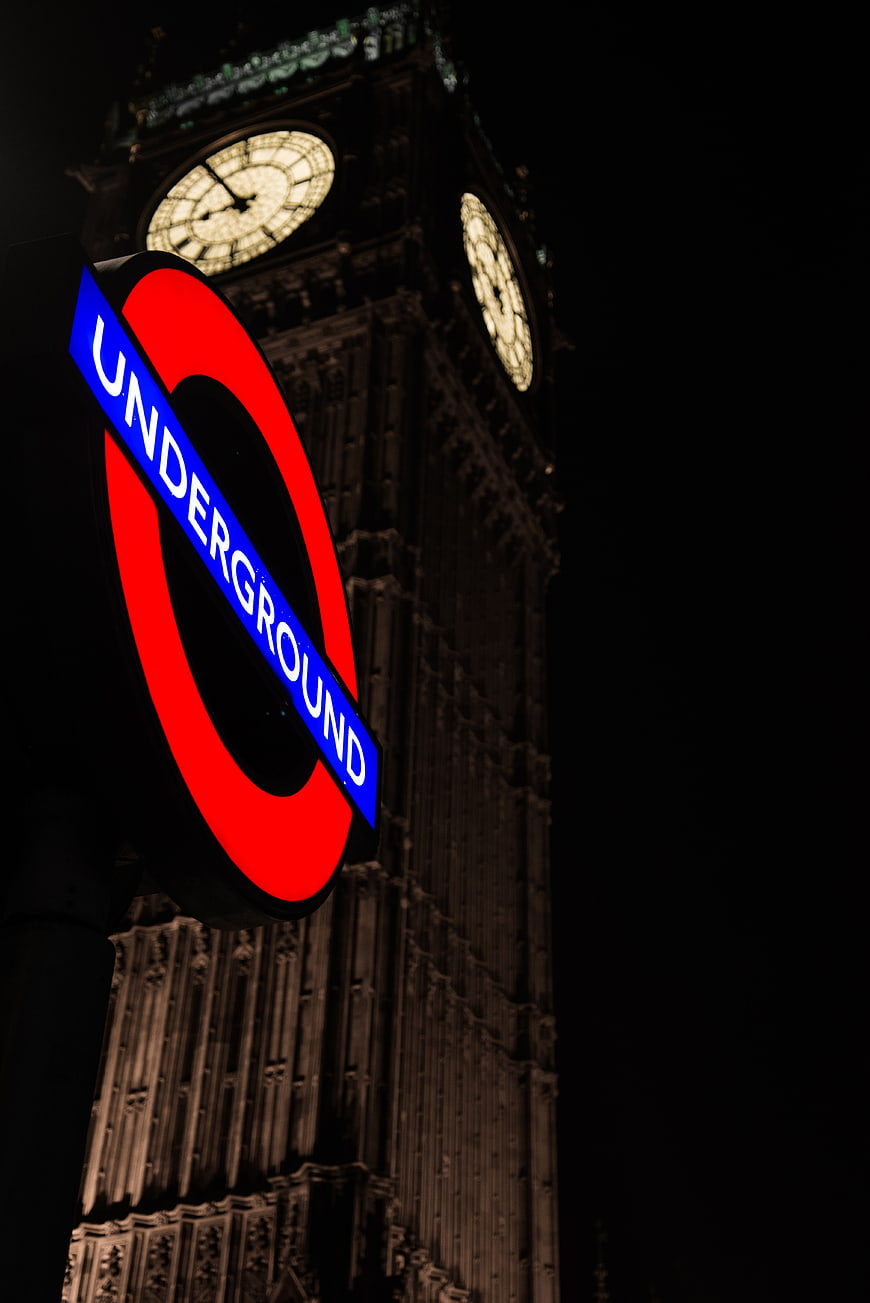 London Underground sign with Big Ben clock tower at night
