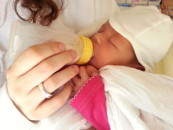 Newborn Baby Being Bottle Fed By Mother