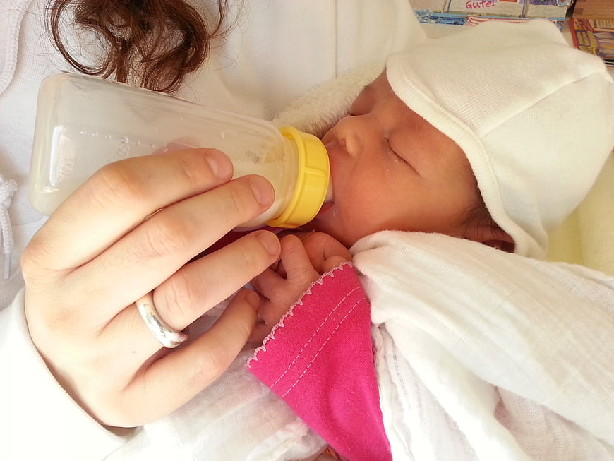 Newborn Baby Being Bottle Fed By Mother