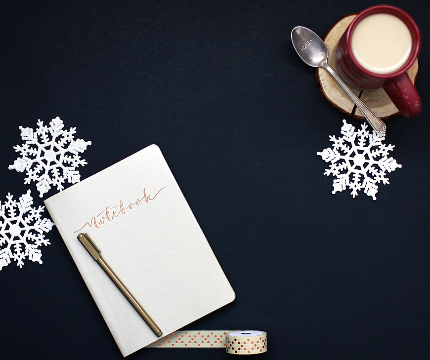 Winter Holiday Flat Lay With Notebook, Pen, Coffee, And Snowflakes