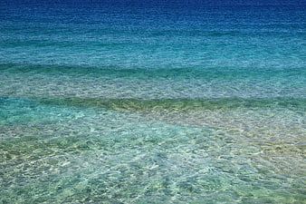 Crystal clear turquoise ocean water with gentle waves