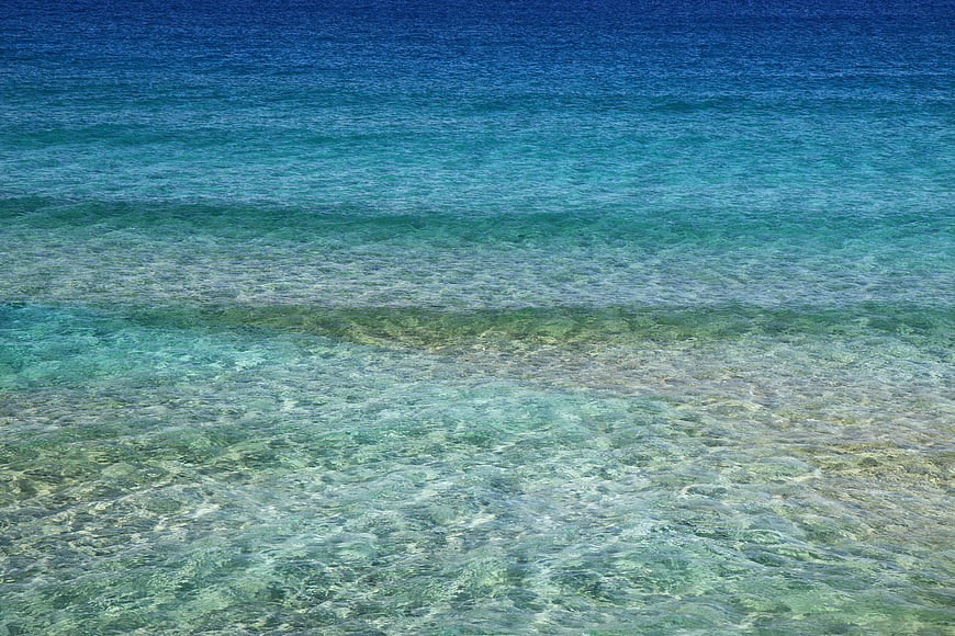 Crystal clear turquoise ocean water with gentle waves