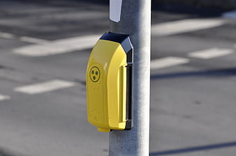 Yellow Pedestrian Crossing Button on Metal Pole