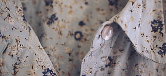Close-up of floral patterned shirt collar with button