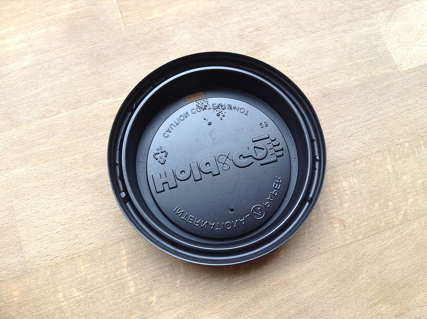 Black Coffee Cup Lid on Wooden Surface