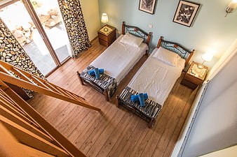 High Angle View of Twin Bedroom with Wooden Floors