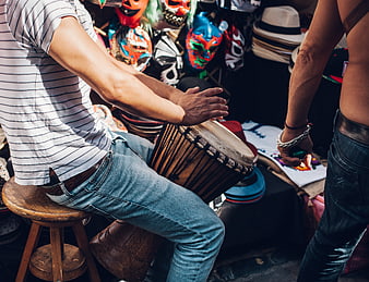 Man Playing Djembe Drum at Outdoor Festival Market