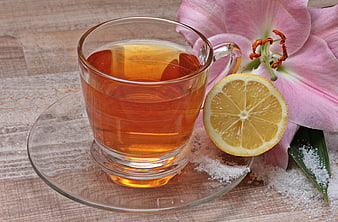 Glass Cup of Tea with Lemon Slice and Pink Lily