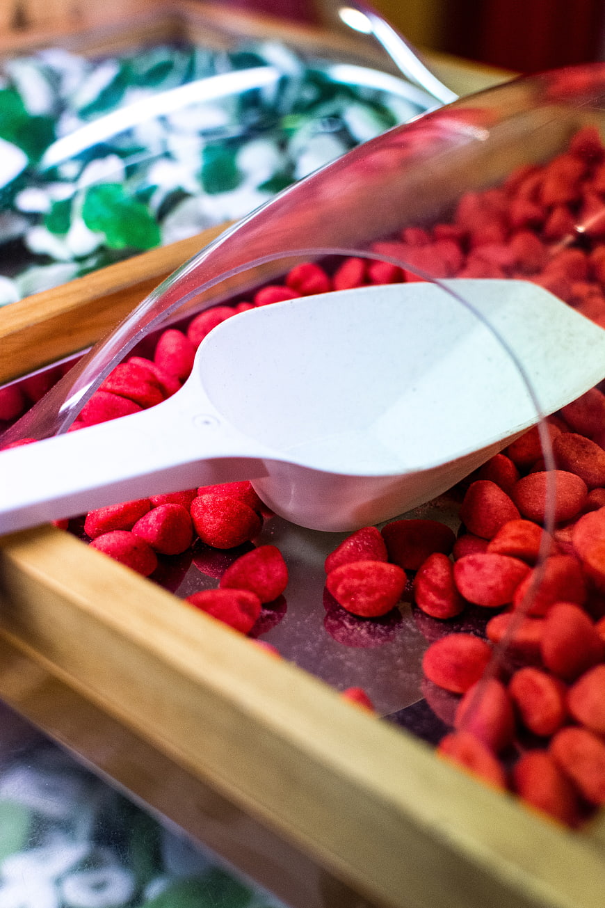 Close-up of red freeze-dried strawberries in a wooden bin