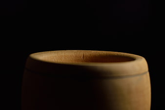 Close-up of wooden mortar on black background