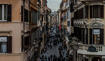 Crowded European Street with Luxury Storefronts and Historic Architecture