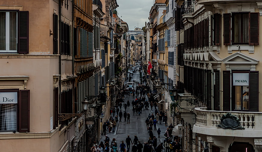 Crowded European Street with Luxury Storefronts and Historic Architecture
