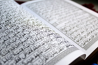 Open Quran Book With Arabic Calligraphy Close Up