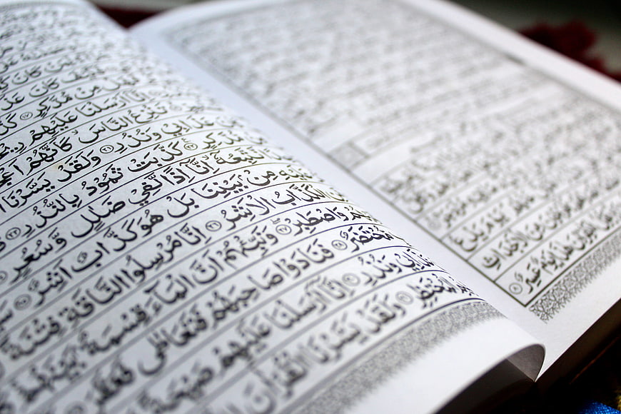 Open Quran Book With Arabic Calligraphy Close Up