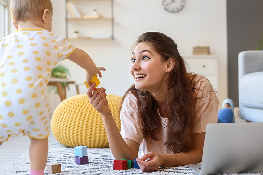 Happy Mother Playing with Toddler at Home