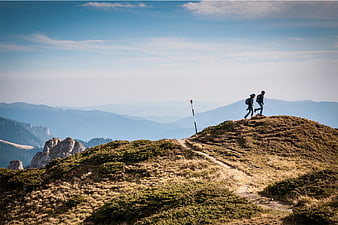 Two Hikers Walking on Mountain Ridge Trail