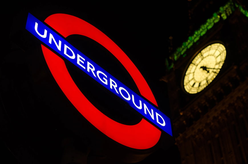 London Underground Sign with Big Ben Clock at Night