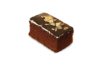 Chocolate cake slice with almond topping on white background