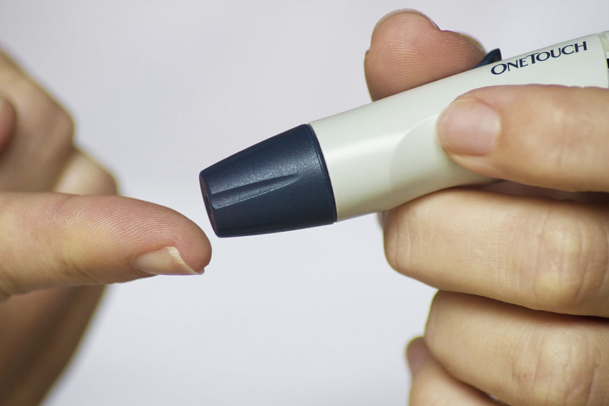 Close-up of OneTouch Glucose Meter Testing Finger