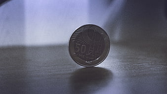 50 Qapik Canadian Coin Standing on Wooden Surface
