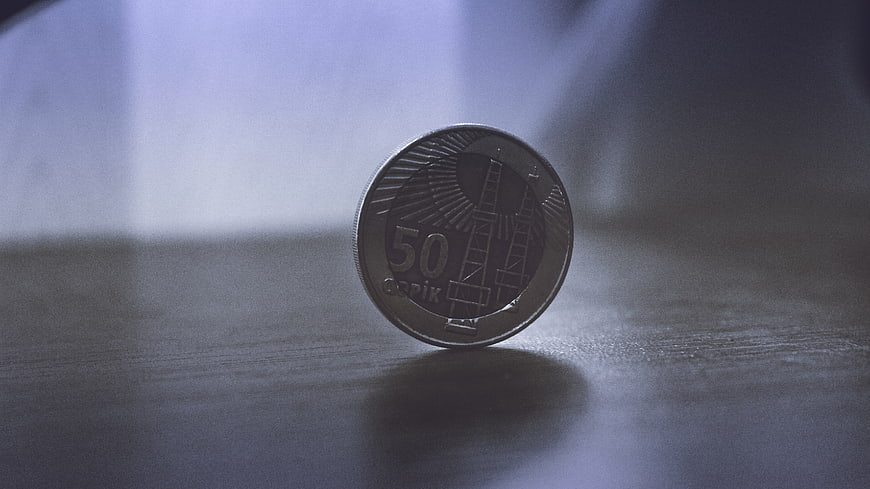 50 Qapik Canadian Coin Standing on Wooden Surface