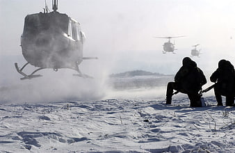 Military helicopters landing in snow with soldiers