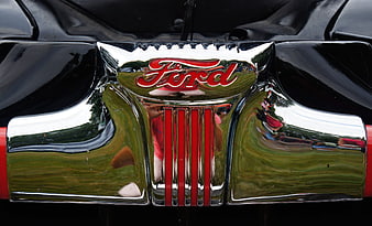 Close-up of vintage Ford car chrome grille emblem