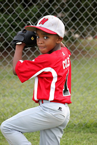 Young African American Baseball Pitcher in Red Jersey