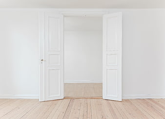 Minimalist white interior with open double doors and wooden floor