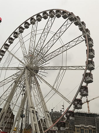 Large White Ferris Wheel Against Overcast Sky