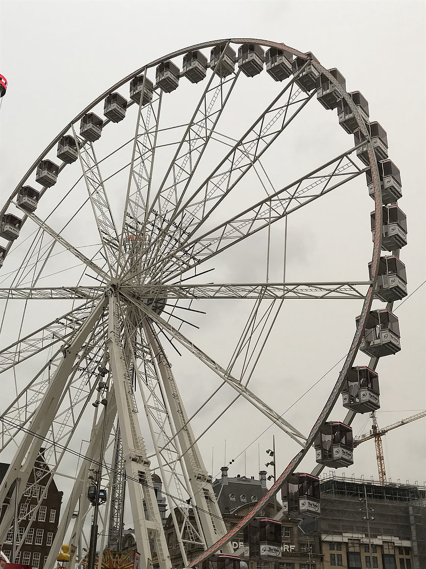 Large White Ferris Wheel Against Overcast Sky