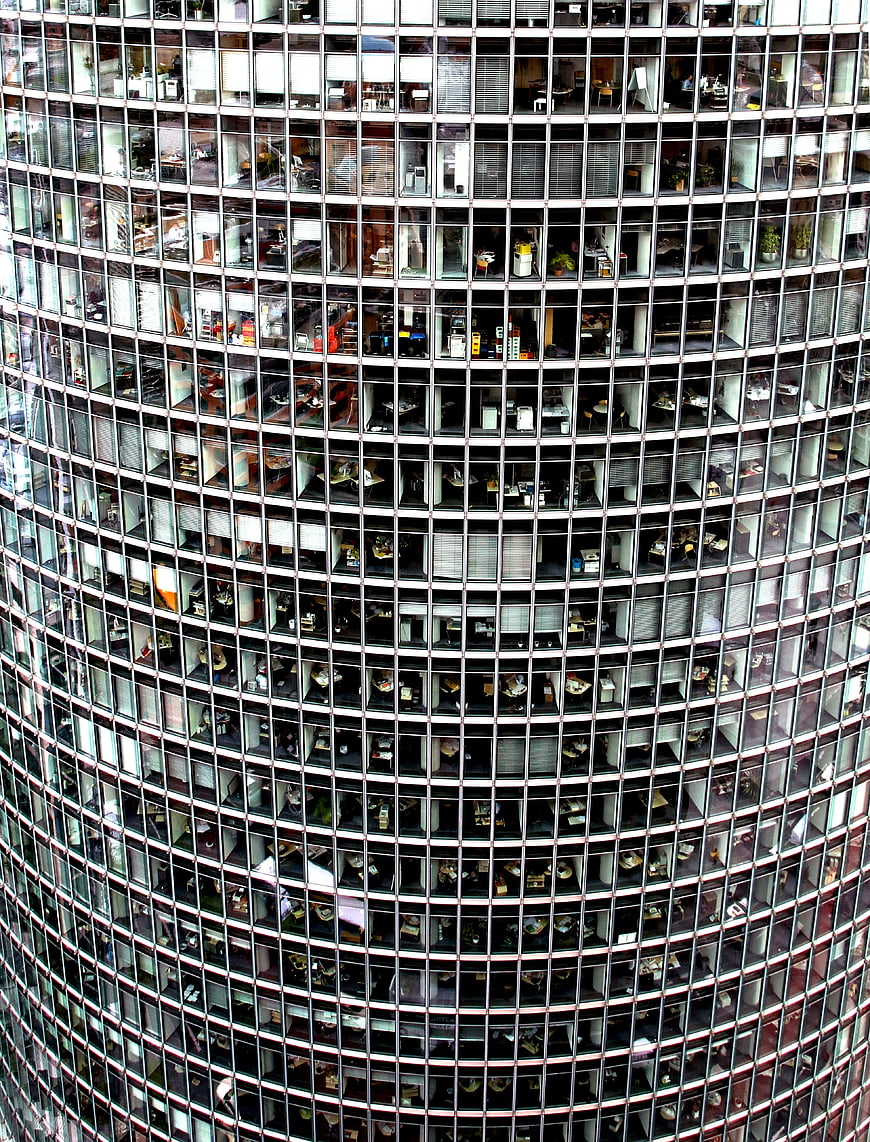 Close-up of curved glass skyscraper facade with office windows
