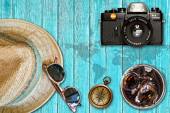 Summer travel accessories on turquoise wooden background