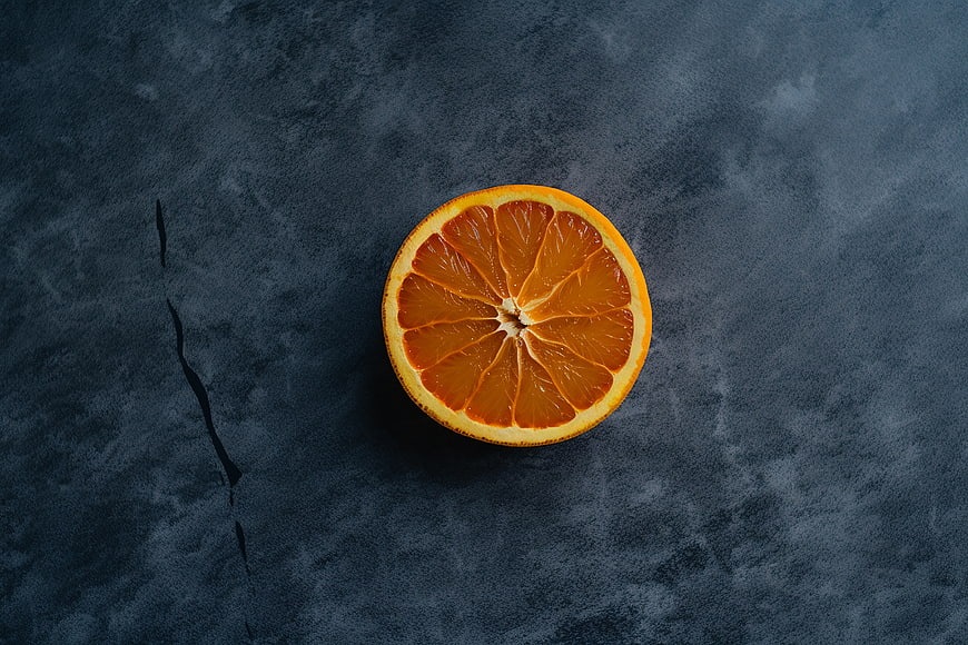 Fresh Orange Slice on Dark Textured Background