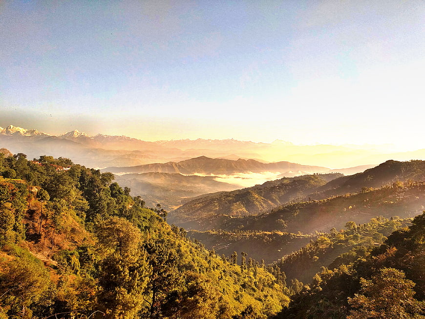 Sunrise Over Misty Mountain Valleys and Forested Hills