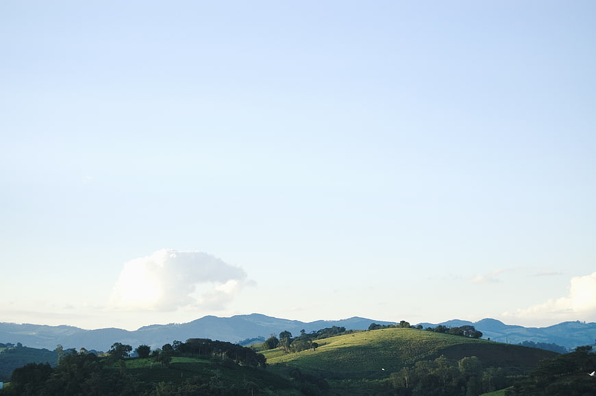 Serene Green Hills and Blue Sky Landscape