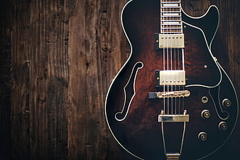 Dark Semi-Hollow Electric Guitar on Rustic Wood Background