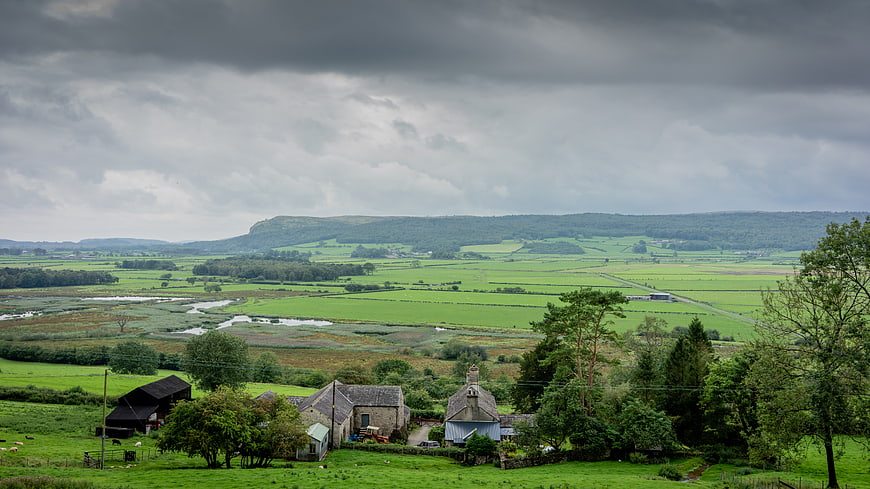 Scenic rural valley landscape with stone farmhouses and green fields