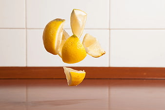 Fresh Lemon Slices Falling in Mid-Air