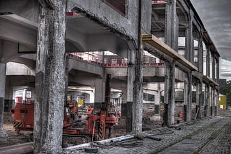 HDR Construction Site with Concrete Pillars and Orange Machinery