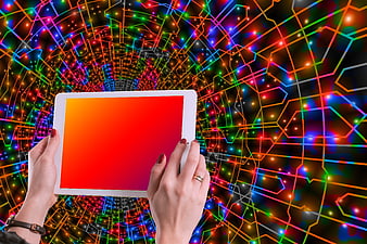 Hands holding tablet with colorful digital network background