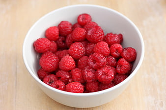 Fresh Raspberries in White Bowl on Wooden Table