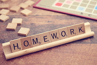 Scrabble Tiles Spelling Homework on Wooden Rack