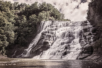 Majestic Tiered Waterfall Cascading Over Rocks in Forest