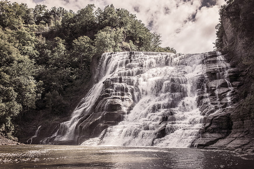 Majestic Tiered Waterfall Cascading Over Rocks in Forest