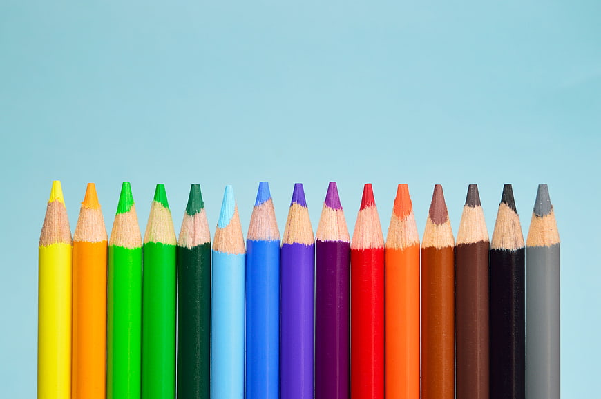 Colorful Colored Pencils Row on Blue Background