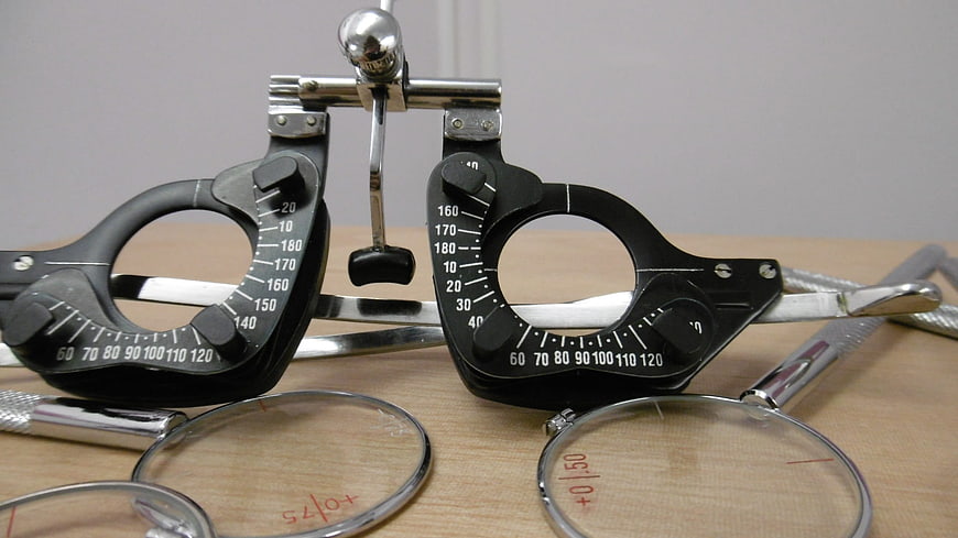 Optometry trial frame and lenses on wooden table