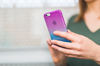 Close-up of Woman Holding Purple and Blue Smartphone